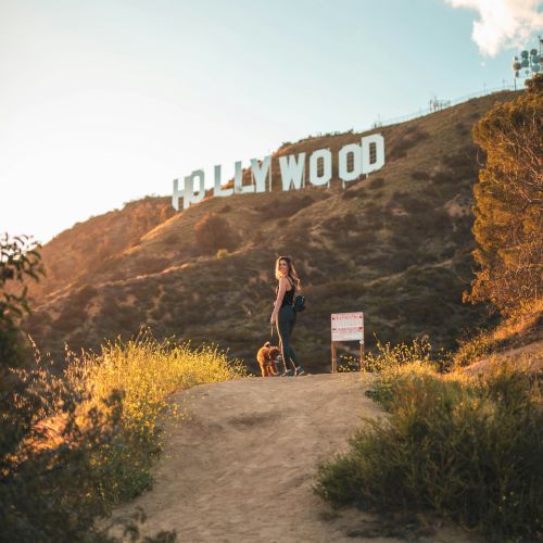 A person stands on a dirt path with 