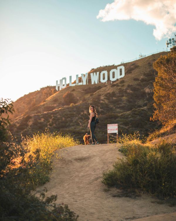 A person stands on a dirt path with 